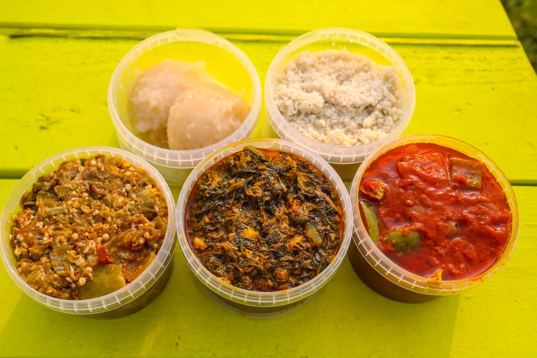 Top: Garri and Fonio (free with any stew or soup); Bottom: Okra and Spinach with Salmon, Edikang Ikong Soup with Beef, West African Red Stew with Chicken ($8 each)